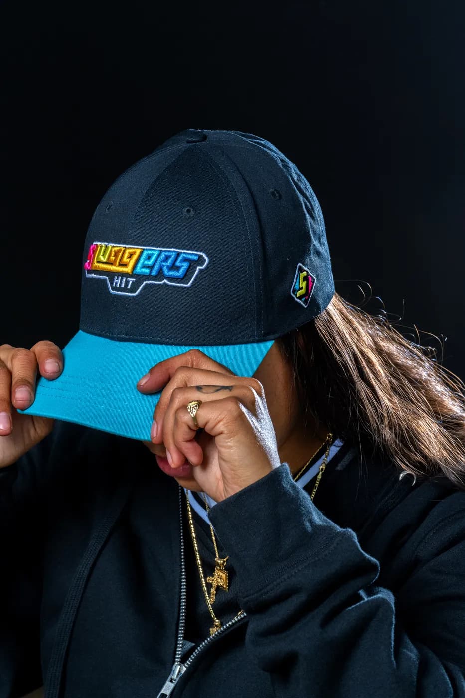 The Spectrum Cap in navy, the wordmark embroidered across the front in a gradient.